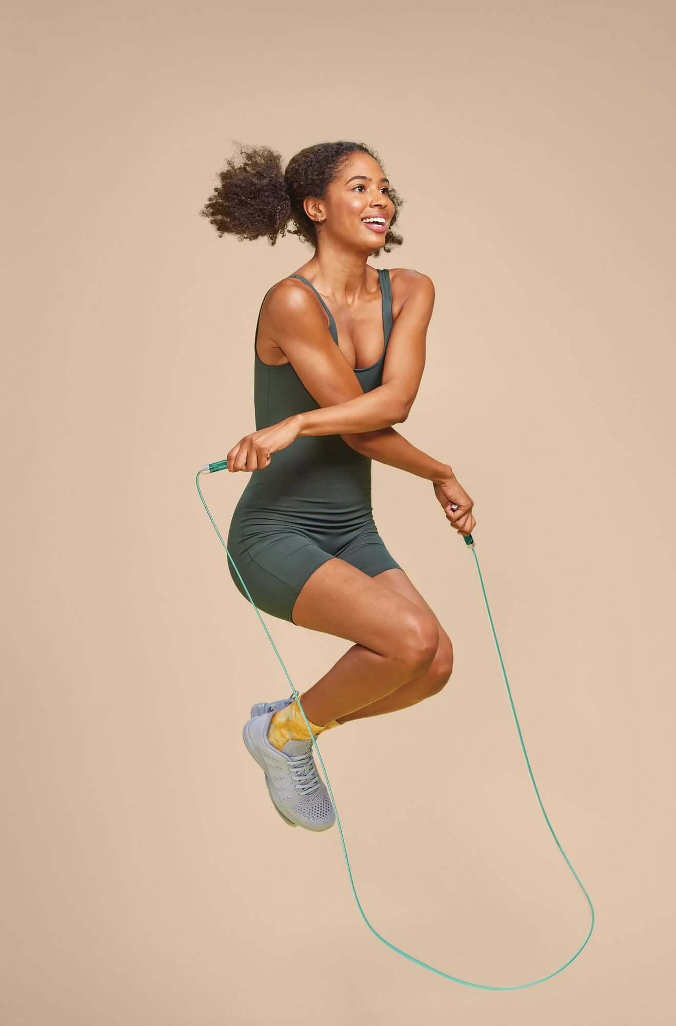 Woman jumping with a Popsugar jump rope, showcasing fitness and cardio workout benefits.